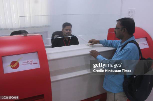 Post officials seen operating after the launch of the India Post Payments Bank , the largest payments bank in the country by network size at VP Road...