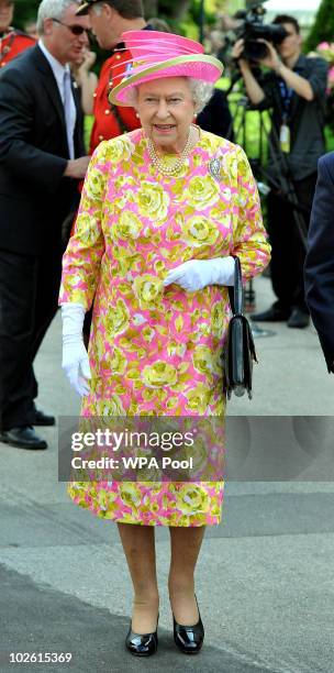 Queen Elizabeth II walks out of Government House to unveil a statue of herself on July 3, 2010 in Winnipeg, Canada. The Queen and Duke of Edinburgh...