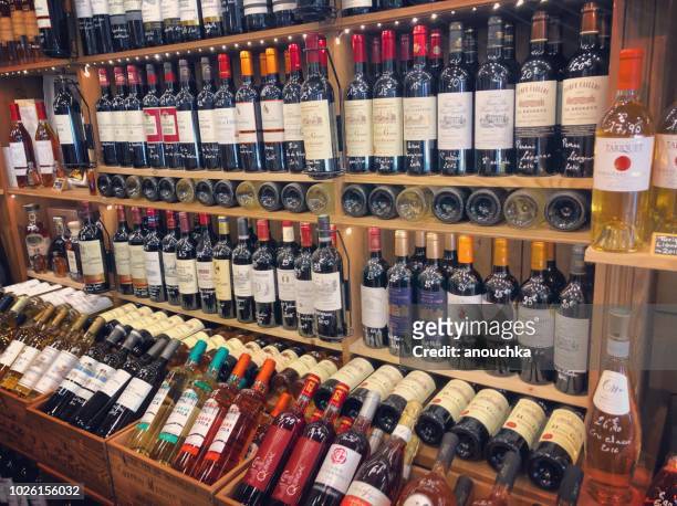 bottles of wine displayed at wine shop in arcachon, france - bordeaux bottle stock pictures, royalty-free photos & images