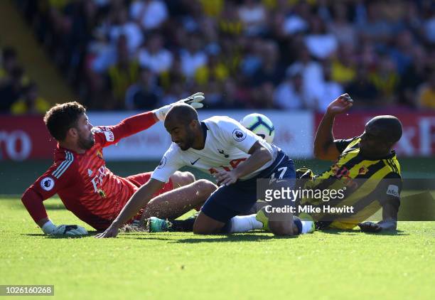 Lucas Moura of Tottenham Hotspur is foiled by Ben Foster and Christian Kabasele of Watford during the Premier League match between Watford FC and...