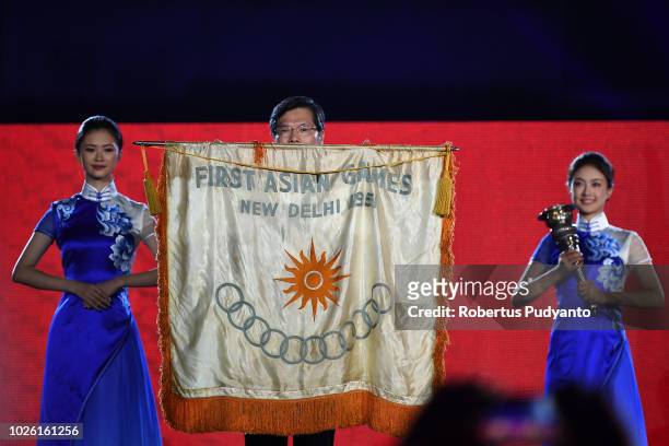 Mayor of Hangzhou Xu Liyi holds the Asian Games first flag during the Asian Games 2018 Closing Ceremony on September 2, 2018 in Jakarta, Indonesia.
