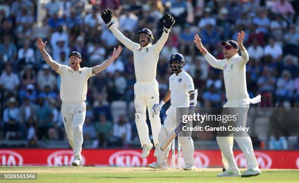 Ben Stokes, Jos Buttler and Joe Root of England successfully appeal for the wicket of Ajinkya Rahane of India during day four of the Specsavers 4th...