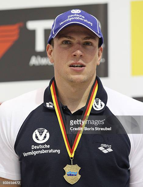 German champion Paul Biedermann of SV Halle/Saale celebrates winning the gold medal on the podium after the men's 200 m freestyle A final during the...