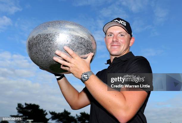 Matt Wallace of England celebrates victory with the trophy in the play-off during the final round on day four of the Made in Denmark played at the...