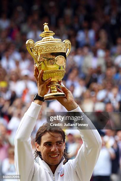 Rafael Nadal of Spain holds the Championship trophy after winning the Men's Singles Final match against Tomas Berdych of Czech Republic on Day...