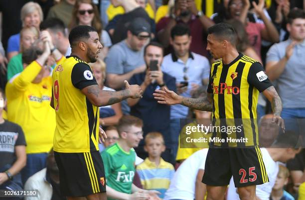 Troy Deeney of Watford celebrates as he scores his team's first goal with Jose Holebas of Watford during the Premier League match between Watford FC...