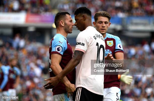 Marcus Rashford of Manchester United and Phil Bardsley of Burnley clash leading to a red card for Rashford during the Premier League match between...