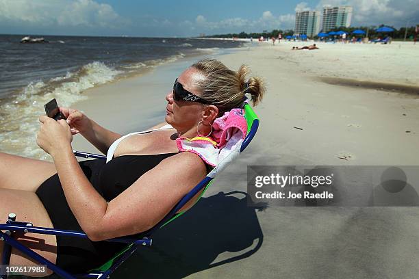 Jackie Norwood on vacation from Oklahoma enjoys the beach despite the threat of contamination from the Deepwater Horizon oil spill in the Gulf of...