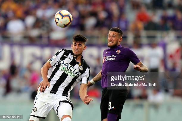 Cristiano Biraghi of ACF Fiorentina battles for the ball with Ignacio Pussetto of Udinese Calcio during the serie A match between ACF Fiorentina and...