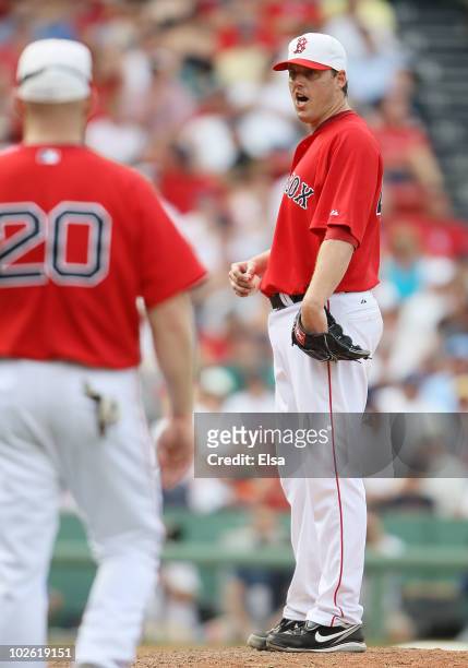 John Lackey of the Boston Red Sox reacts as he is pulled from the game against the Baltimore Orioles on July 4, 2010 at Fenway Park in Boston,...
