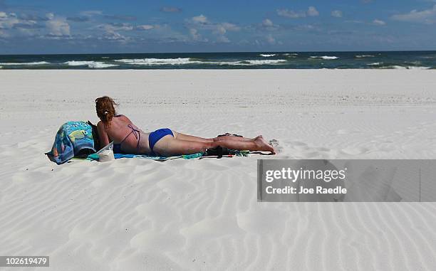 Joy Laux on vacation from Missouri enjoys an empty beach as people stayed away due to the threat of contamination from the Deepwater Horizon oil...