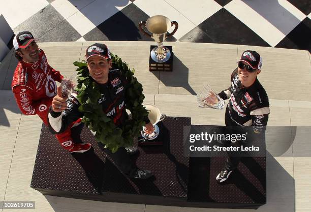 Dario Franchitti, Will Power and Ryan Briscoe celebrate on the podium after the the IZOD IndyCar Series Camping World Grand Prix at the Glen at...