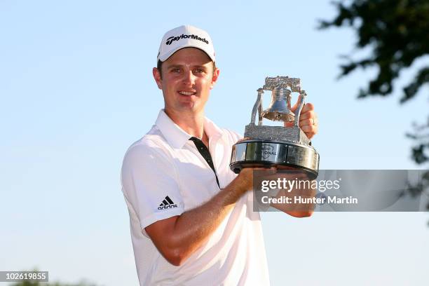 Justin Rose of England celebrates with the AT&T National tournament trophy after he won the tournment following the final round of the AT&T National...