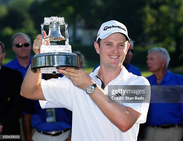 Justin Rose of England holds the champion's trophy after his win at the AT&T National at Aronimink Golf Club on July 4, 2010 in Newtown Square,...