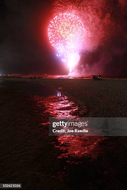 Fourth of July fireworks light up a slick of oil on the beach after it washed ashore from the Deepwater Horizon oil spill in the Gulf of Mexico on...