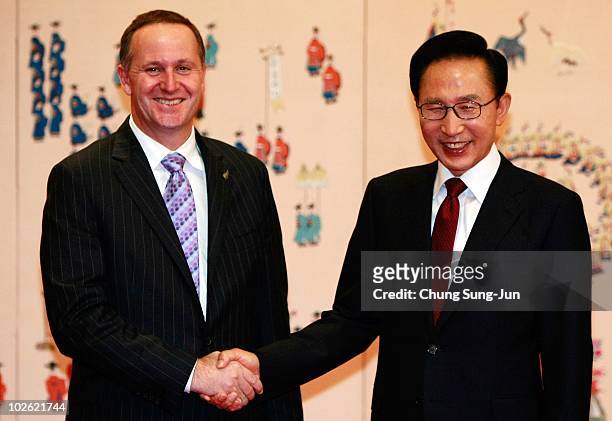 New Zealand Prime Minister John Key shakes hands with South Korean President Lee Myung-Bak before their meeting at the presidential house on July 5,...