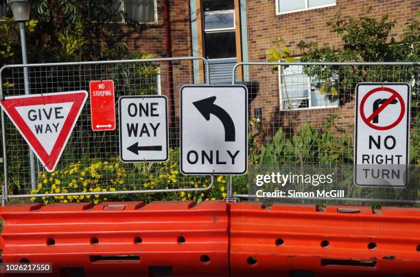 multiple road signs near inner city road construction - sydney road stock pictures, royalty-free photos & images