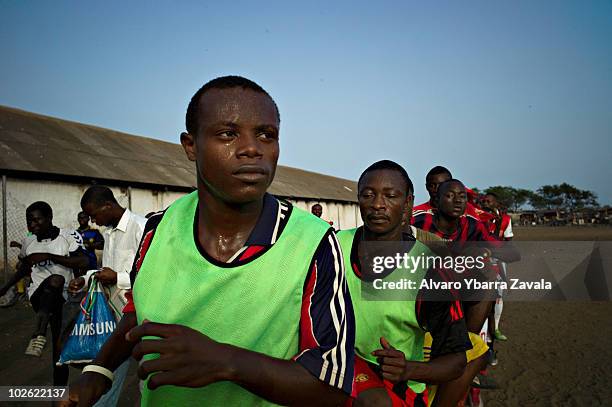 Local football team taking part in training on the main pitch in the Agbogbloshie slum in Accra, Ghana. There are many young people in this area who...