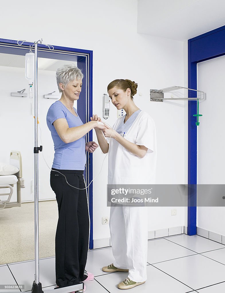 Nurse controlling IV drip