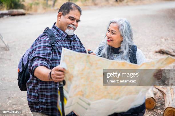 senior mexican couple looking at map - plotting a path stock pictures, royalty-free photos & images