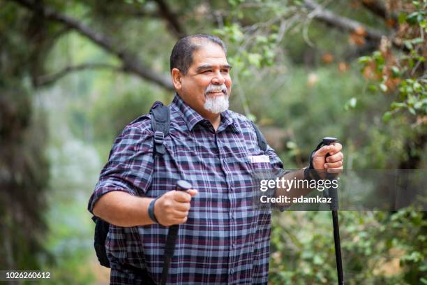 senior mexican man hiking - heavy backpack stock pictures, royalty-free photos & images