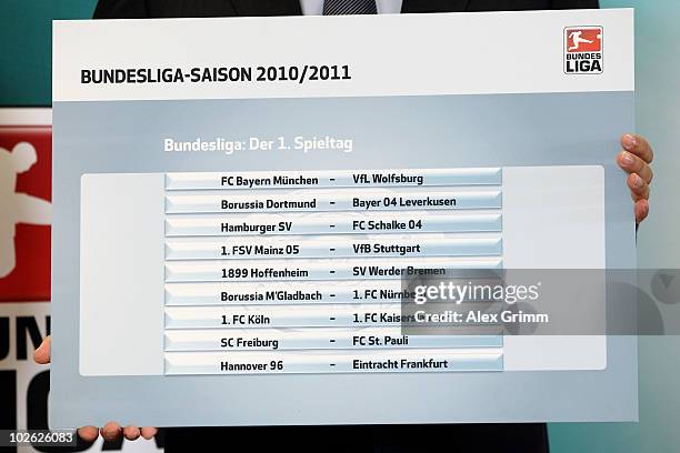 Christian Seifert, general manager of the German Football League , holds up a placard showing the first matchday one of the 2010/2011 Bundesliga...