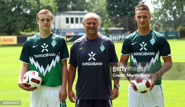 Thomas Schaaf , head coach of Bremen poses with new player Felix Kroos and Marko Arnautovic prior to the Werder Bremen first training session for the...