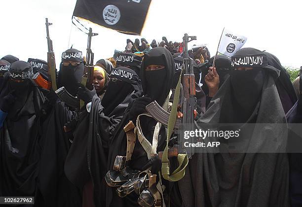 Somali women carry weapons during a demonstration organized by the islamist Al-Shabaab group which is fighting the Somali government in Suqa Holaha...