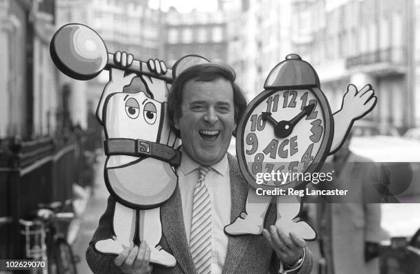 Irish radio and television presenter Terry Wogan poses with an alarm clock on April 04, 1984.