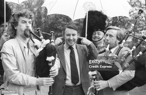 Comedian Billy Connolly plays the bagpipes for Scottish politician and leader of the Liberal Party David Steel on March 20, 1984.