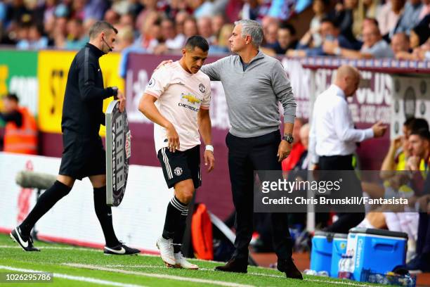 Alexis Sanchez of Manchester United is hugged by Manager of Manchester United Jose Mourinho after being substituted during the Premier League match...