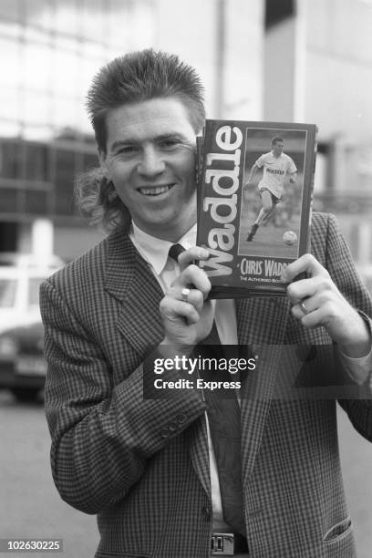 Tottenham Hotspur and England footballer Chris Waddle poses with a copy of his biography on November 04, 1988.