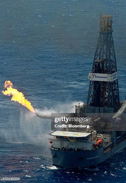 The Transocean Ltd. Discoverer Enterprise drill ship, leased by BP Plc, burns off gas and collects up to 19,000 barrels of oil per day at the site of...