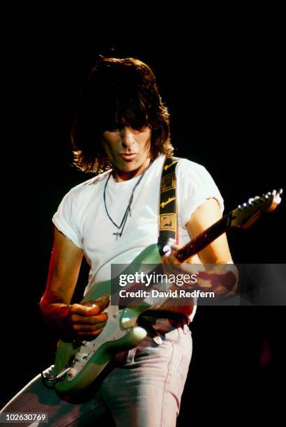 English rock guitarist Jeff Beck performs live on stage playing a Fender Signature Stratocaster guitar at the Hammersmith Odeon in London in July...