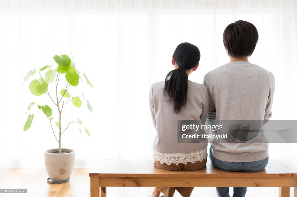 Young asian couple in living room lifestyle image