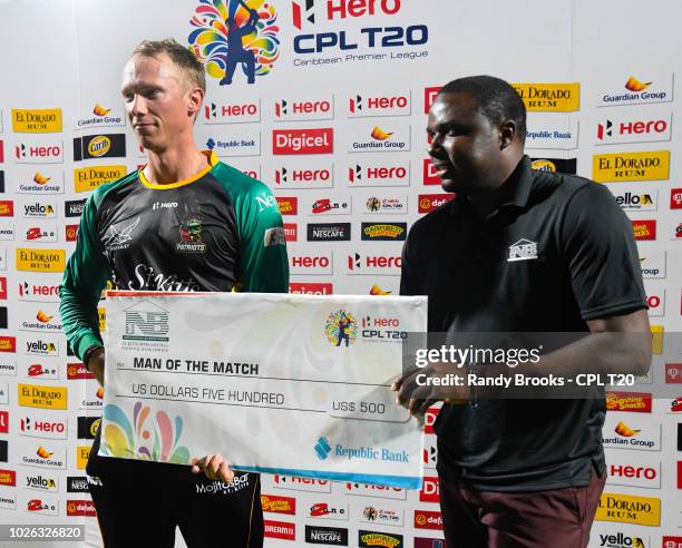 In this handout image provided by CPL T20, Rassie van der Dussen of St Kitts & Nevis Patriots receives the man of the match prize from Alexis Nisbett...