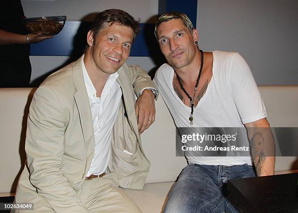 President and CEO of Universal Music Germany Frank Briegmann chats with former handball star Stefan Kretzschmar during the Universal Pop up store...