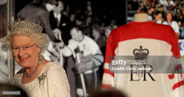 Queen Elizabeth II smiles as she walks past a hockey shirt she was given during a dinner at the Royal York Hotel on July 5, 2010 in Toronto, Canada....