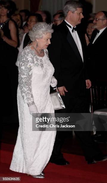 Queen Elizabeth II and Canadian Prime Minister Stephen Harper arrive at a dinner at the Royal York Hotel on July 5, 2010 in Toronto, Canada. The...