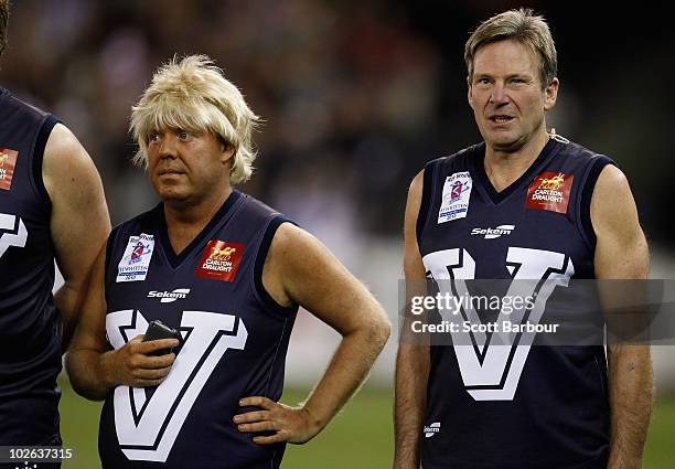 Comedian Peter Helliar in character as AFL footballer Bryan Strauchan and Sam Newman line up on the field before the 2010 EJ Whitten Legends AFL Game...