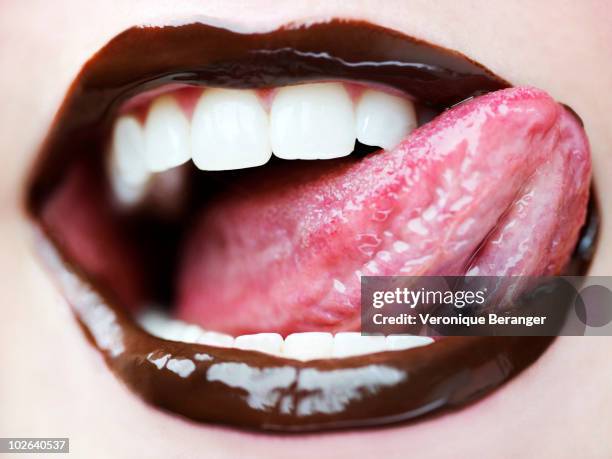 chocolate mouth - human tongue stock-fotos und bilder