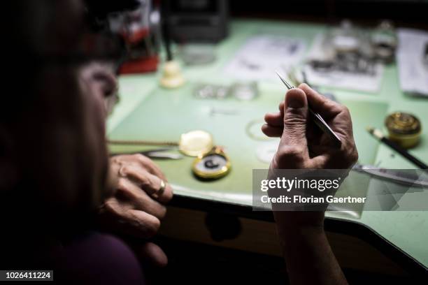 Watchmaker repairs a pocket watch in his workshop on August 16, 2018 in Weisswasser, Germany.