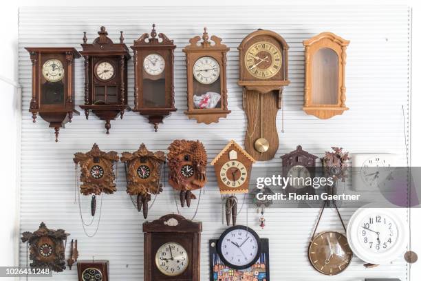 Clocks hang on a wall in a watchmaker's workshop on August 16, 2018 in Weisswasser, Germany.