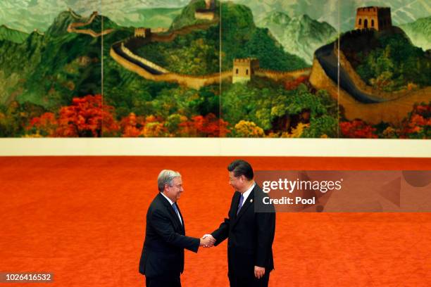 United Nations Secretary-General Antonio Guterres, left, shakes hands with Chinese President Xi Jinping during the Forum on China-Africa Cooperation...