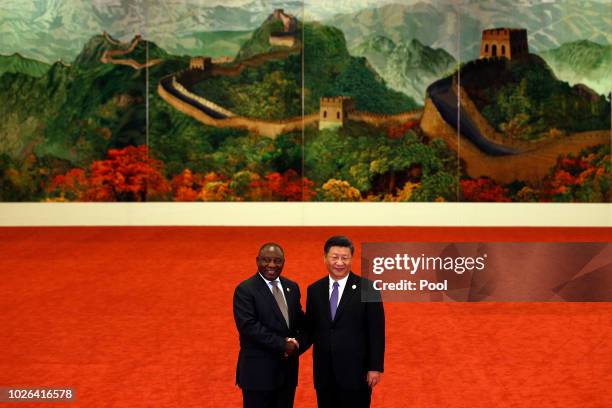 South African President Cyril Ramaphosa, left, shakes hands with Chinese President Xi Jinping as they pose for photographers during the Forum on...