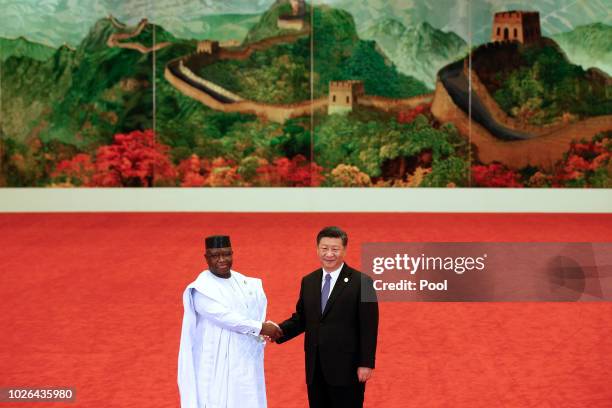 Sierra Leone President Julius Maada Bio, left, shakes hands with Chinese President Xi Jinping during the Forum on China-Africa Cooperation held at...