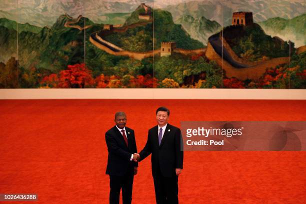 Angola's President Joao Lourenco, left, shakes hands with Chinese President Xi Jinping during the Forum on China-Africa Cooperation held at the Great...