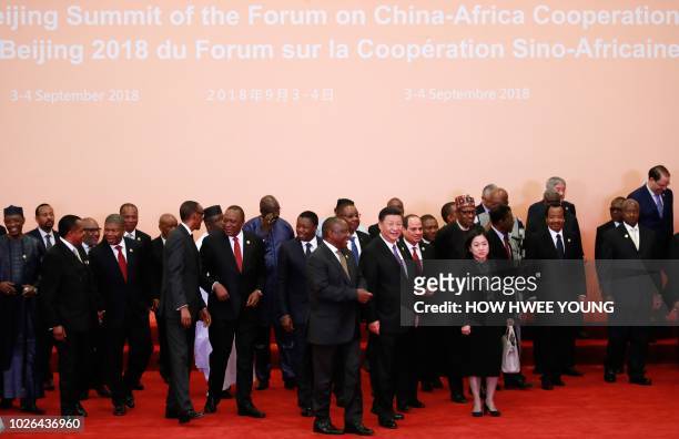 China's President Xi Jinping and African leaders walk together after a photo session during the Forum on China-Africa Cooperation in Beijing on...