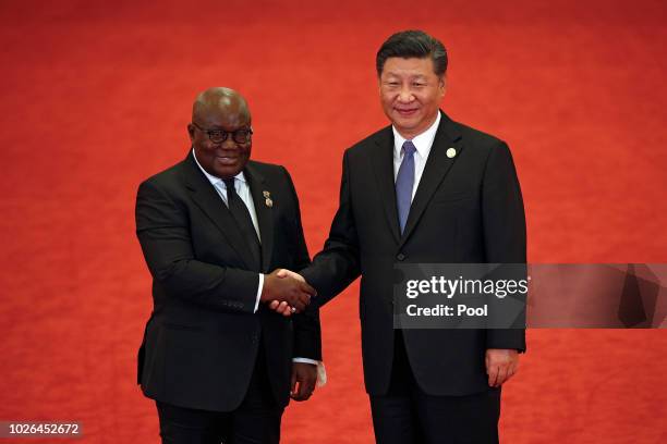 Ghana's President Nana Akufo-Addo, left, shakes hands with Chinese President Xi Jinping during the Forum on China-Africa Cooperation held at the...