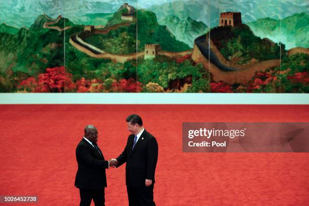 Ghana's President Nana Akufo-Addo, left, shakes hands with Chinese President Xi Jinping during the Forum on China-Africa Cooperation held at the...